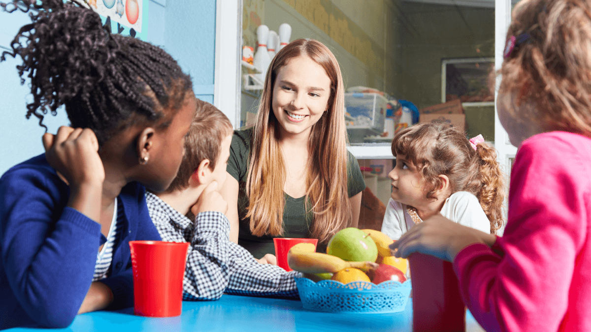 key-person with group of children at nursery