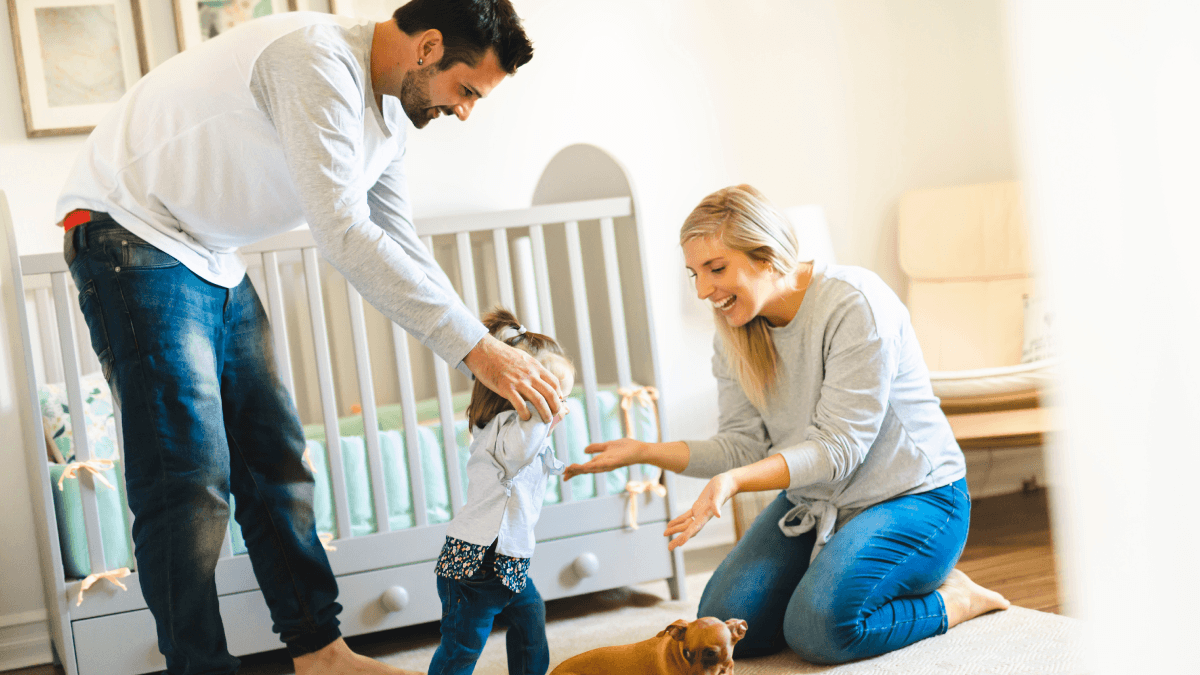 parents with child helping to walk